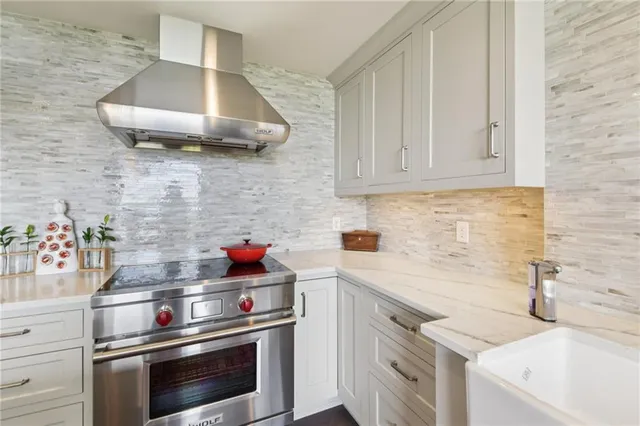 a kitchen with stainless steel appliances a stove and cabinets