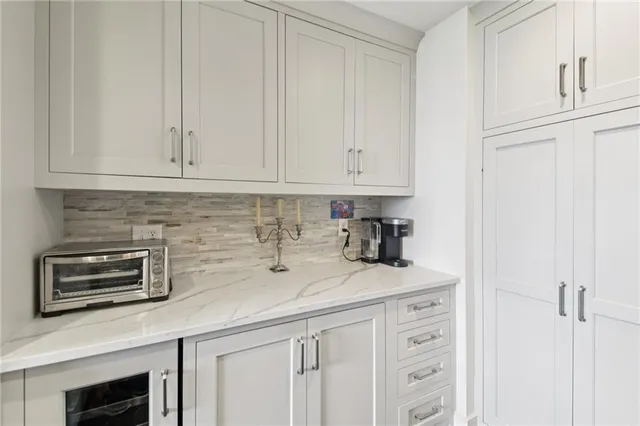 a kitchen with white cabinets and a sink