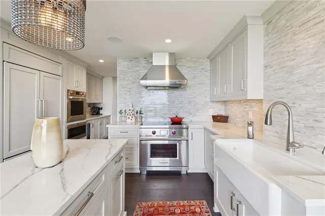a kitchen with kitchen island a stove a sink and a refrigerator
