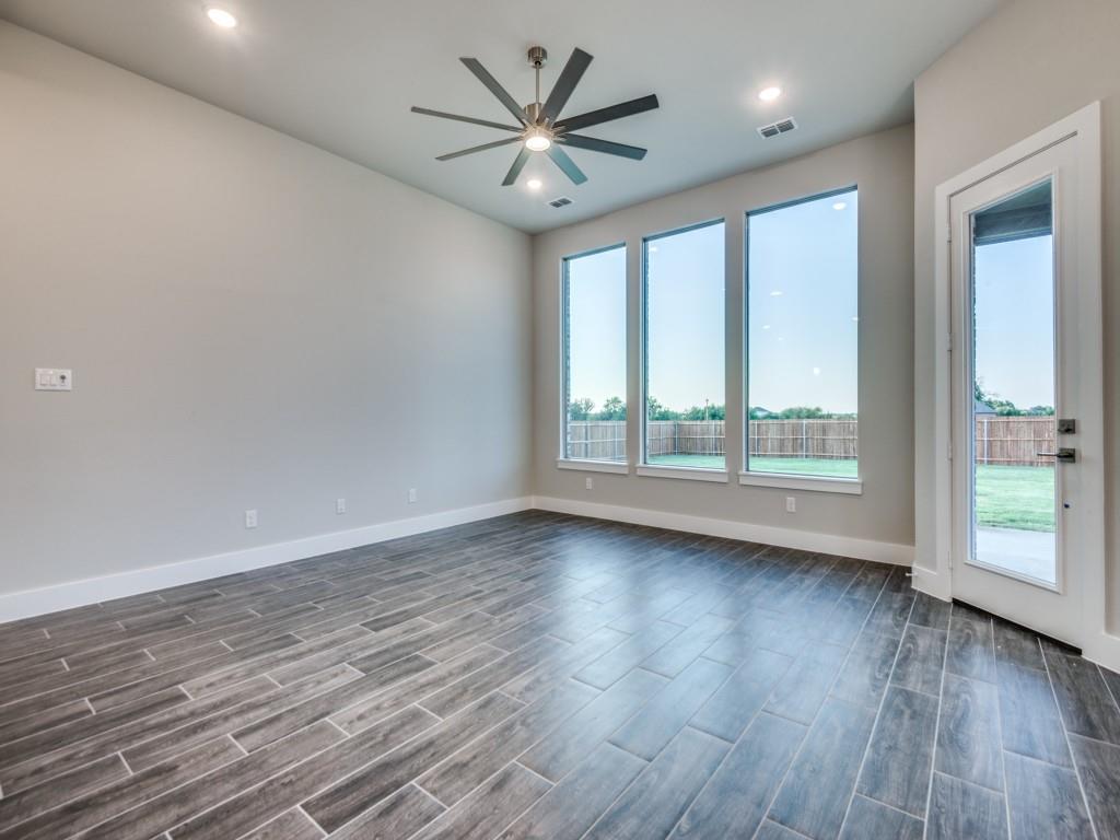 139 Lakeview Circle Pilot Point, TX 76258 - Photo 4 of 19 Unfurnished room with visible vents, baseboards, dark wood-type flooring, and a ceiling fan