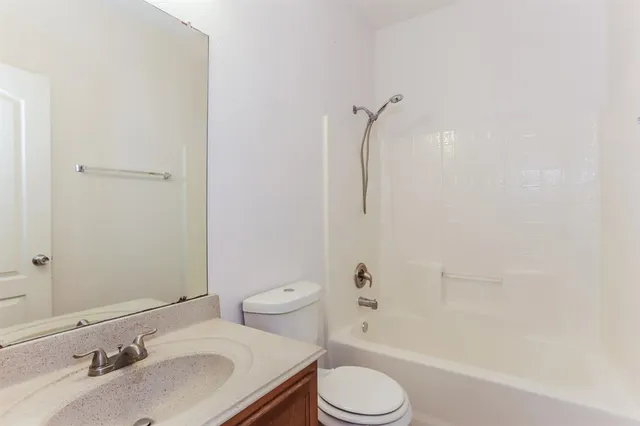 a bathroom with a sink toilet vanity and shower