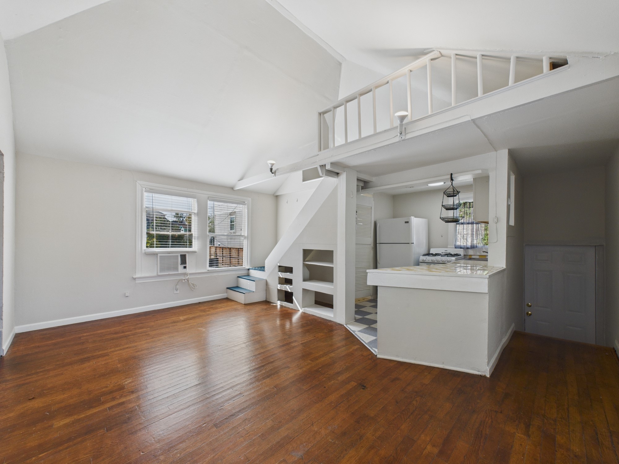 1920 Richmond Avenue, Unit 17 Houston, TX 77098 - Photo 2 of 17 a view of empty room with wooden floor and fireplace