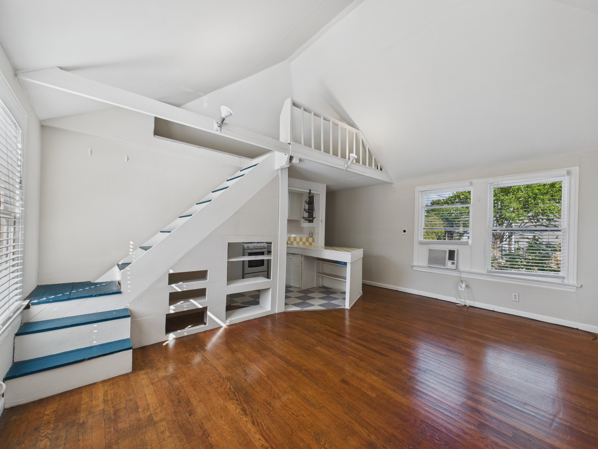 1920 Richmond Avenue, Unit 17 Houston, TX 77098 - Photo 3 of 17 a view of an empty room with a window and wooden floor