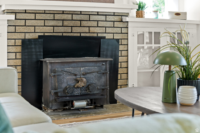 189 West Center Street Midvale, UT 84047 - Photo 8 of 64 Unique brick fireplace hearth featuring a cast iron wood-burning stove