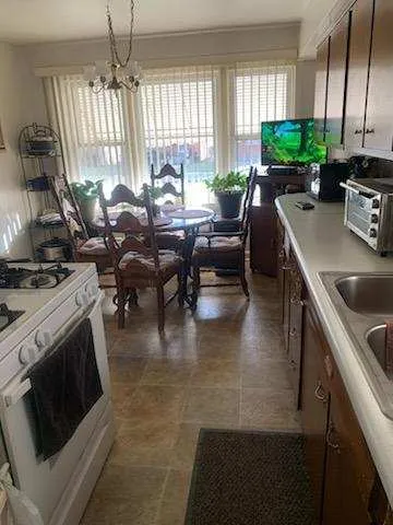 a kitchen with stainless steel appliances granite countertop sink stove and cabinets