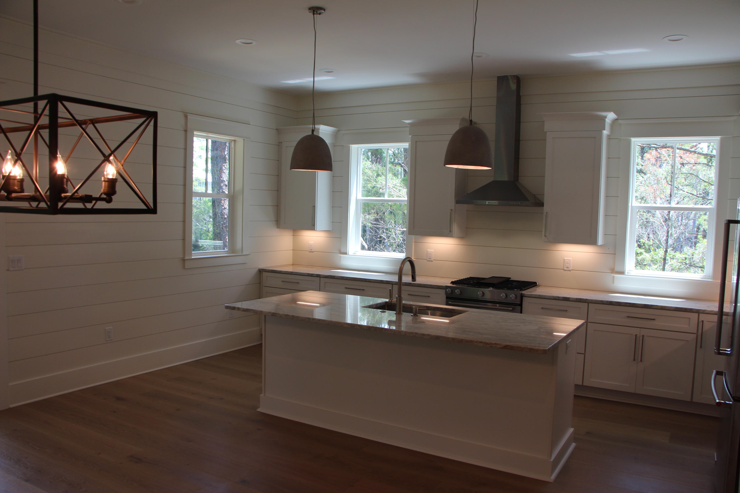 302 Cabana Trail Santa Rosa Beach, FL 32459 - Photo 2 of 8 a kitchen with stainless steel appliances granite countertop a sink a stove and a wooden floors