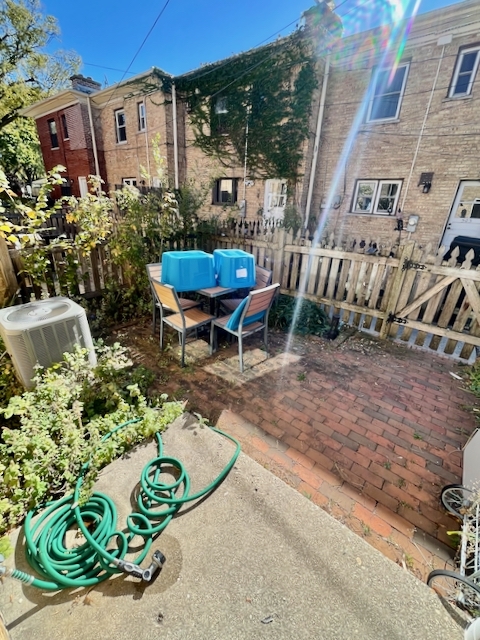 511 1/2 1/2 Ridge Road Wilmette, IL 60091 - Photo 19 of 20 a view of a chair and table in backyard of the house