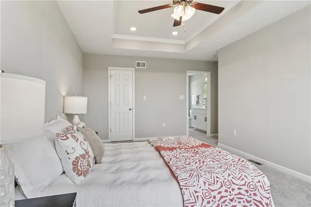 a bedroom with a large bed and a chandelier