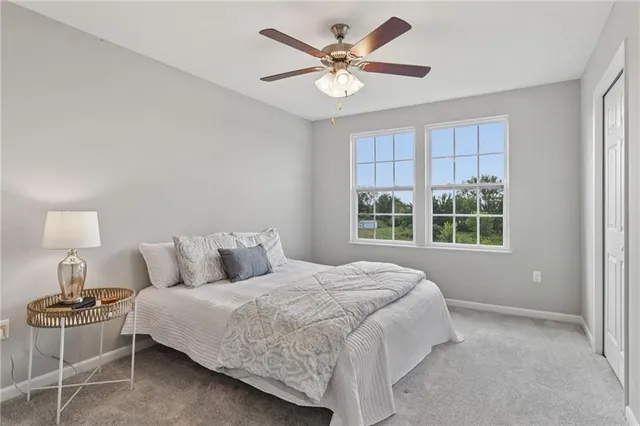 a bedroom with a bed and a table with chair