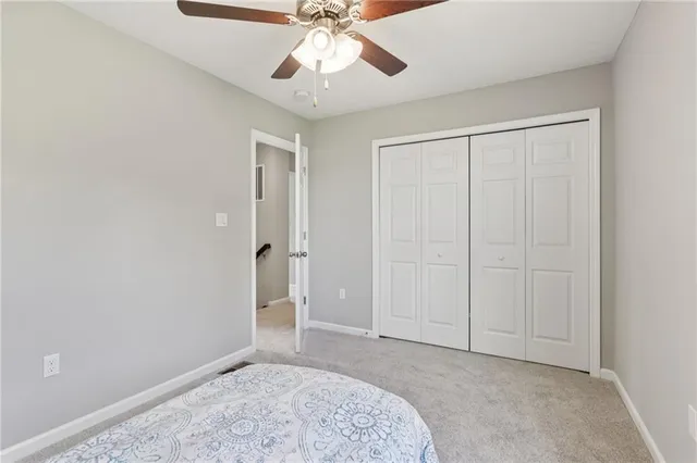 an empty room with fan and entrance