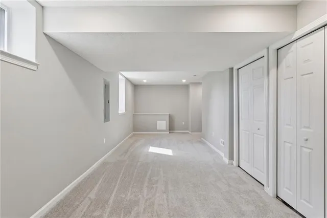 a view of a big room with closet and windows