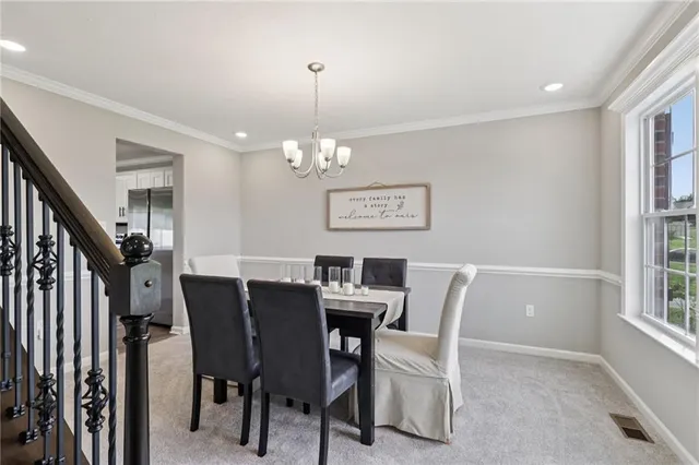 a view of a dining room with furniture and window