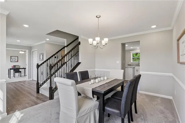 a view of a dining room with furniture and a chandelier