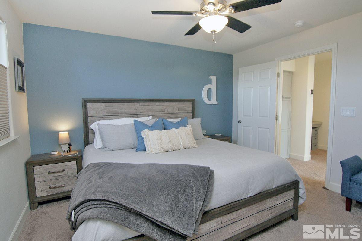 1910 Bears Ranch Drive Reno, NV 89521 - Photo 11 of 20 a bedroom with a bed and a chandelier