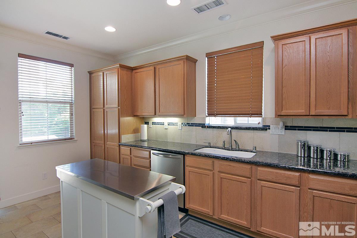 1910 Bears Ranch Drive Reno, NV 89521 - Photo 4 of 20 a kitchen with stainless steel appliances granite countertop a sink stove and cabinets
