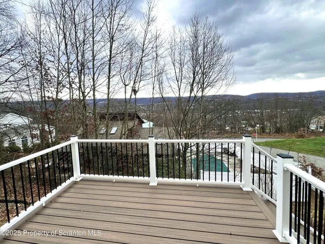 a view of balcony with wooden floor and fence