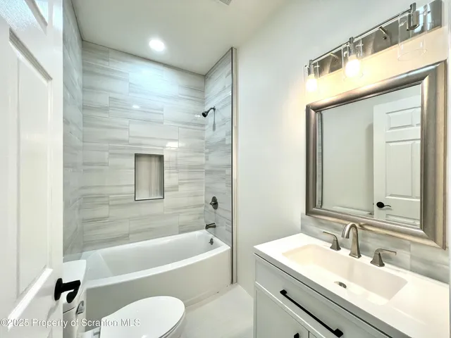 a bathroom with a sink a toilet and bathtub