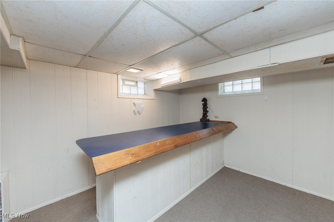 3801 Baird Road Stow, OH 44224 - Photo 24 of 31 Bar featuring wooden counters, dark colored carpet, a drop ceiling, and wood walls