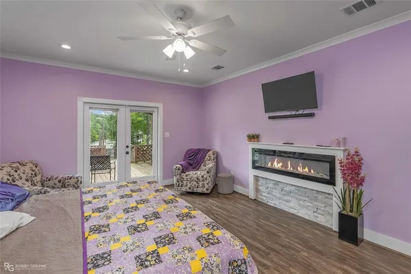 a bedroom with furniture and a flat screen tv