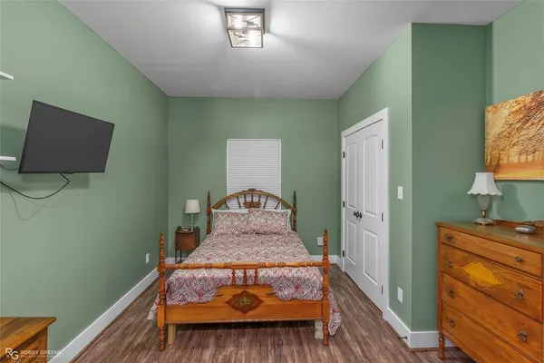 a bed sitting in a bedroom next to a window with dresser
