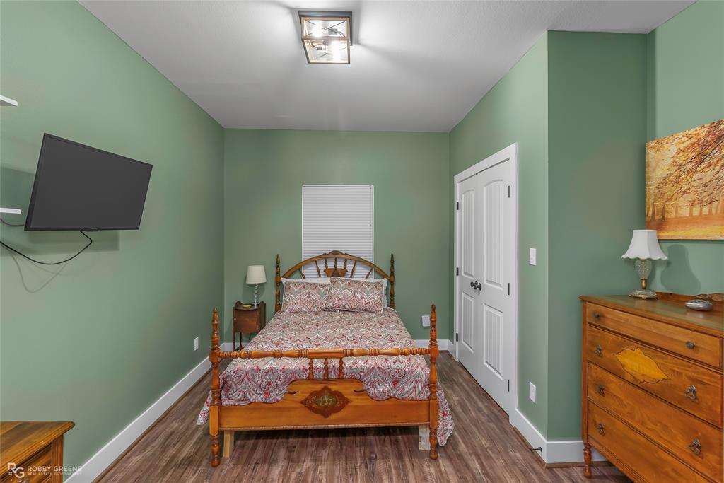 1072 Featherston Road Homer, LA 71040 - Photo 30 of 40 a bed sitting in a bedroom next to a window with dresser