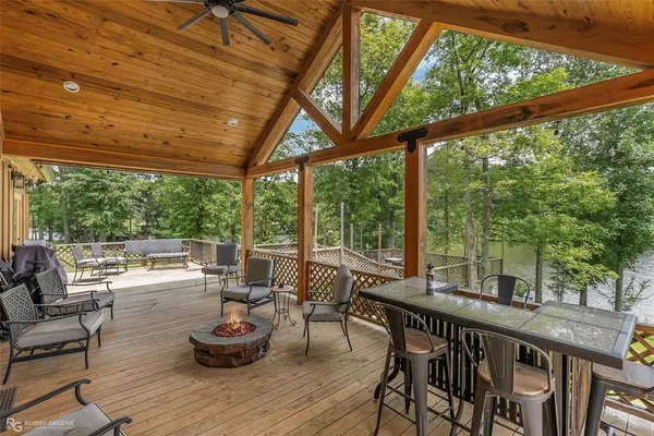 a view of a patio with lawn chairs and wooden floor
