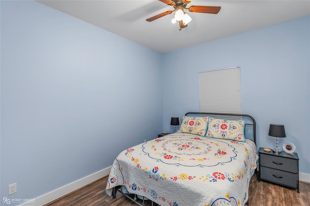 1072 Featherston Road Homer, LA 71040 - Photo 33 of 40 a bedroom with a bed and a chandelier
