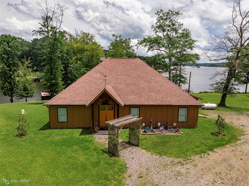 1072 Featherston Road Homer, LA 71040 - Photo 36 of 40 a front view of a house with a garden and trees