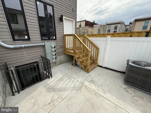 a view of a balcony with two chairs and a barbeque