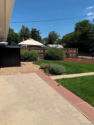 a swimming pool with outdoor seating and yard