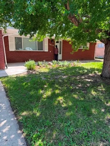 a view of a house with a yard porch and sitting area