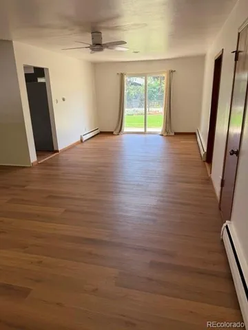 wooden floor in an empty room with a window