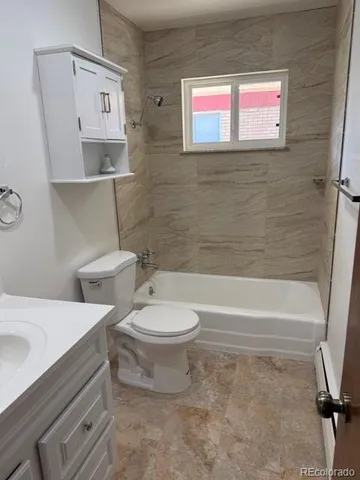 a bathroom with a toilet a sink and bathtub