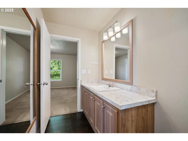 a bathroom with a sink a vanity and a mirror