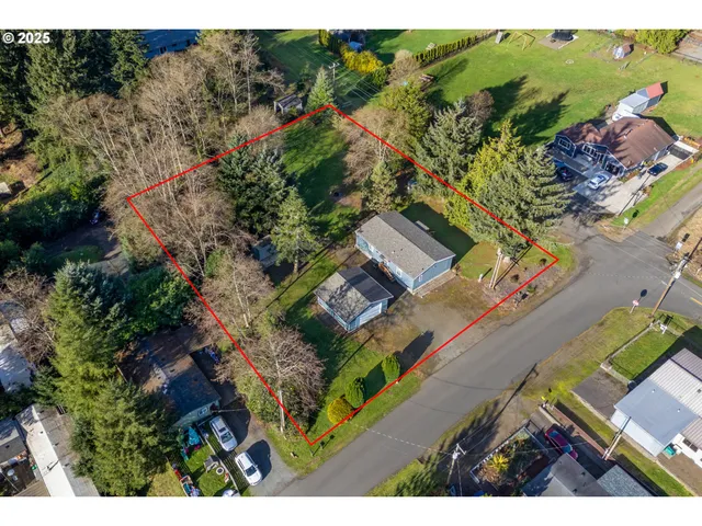 an aerial view of a house with a yard