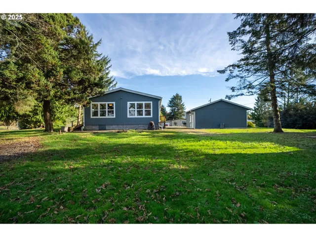 a view of house with a yard