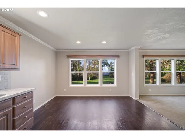 a view of wooden floor and windows in a room