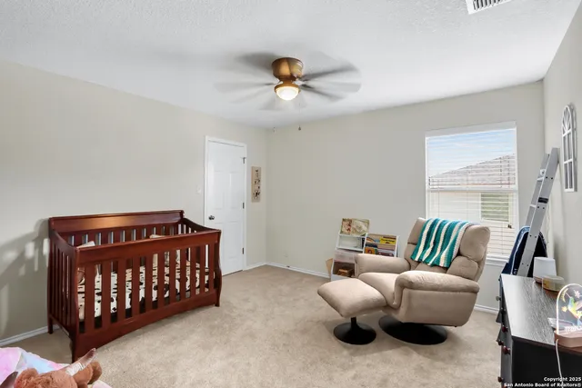 a bedroom with furniture and a large window