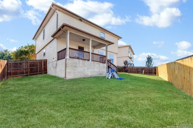 a view of backyard with small cabin