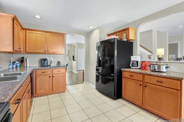 a kitchen with stainless steel appliances granite countertop a refrigerator sink and cabinets