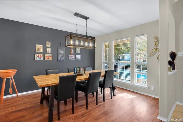 a view of a dining room with furniture window and wooden floor