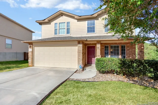 a view of a house with a yard and plants