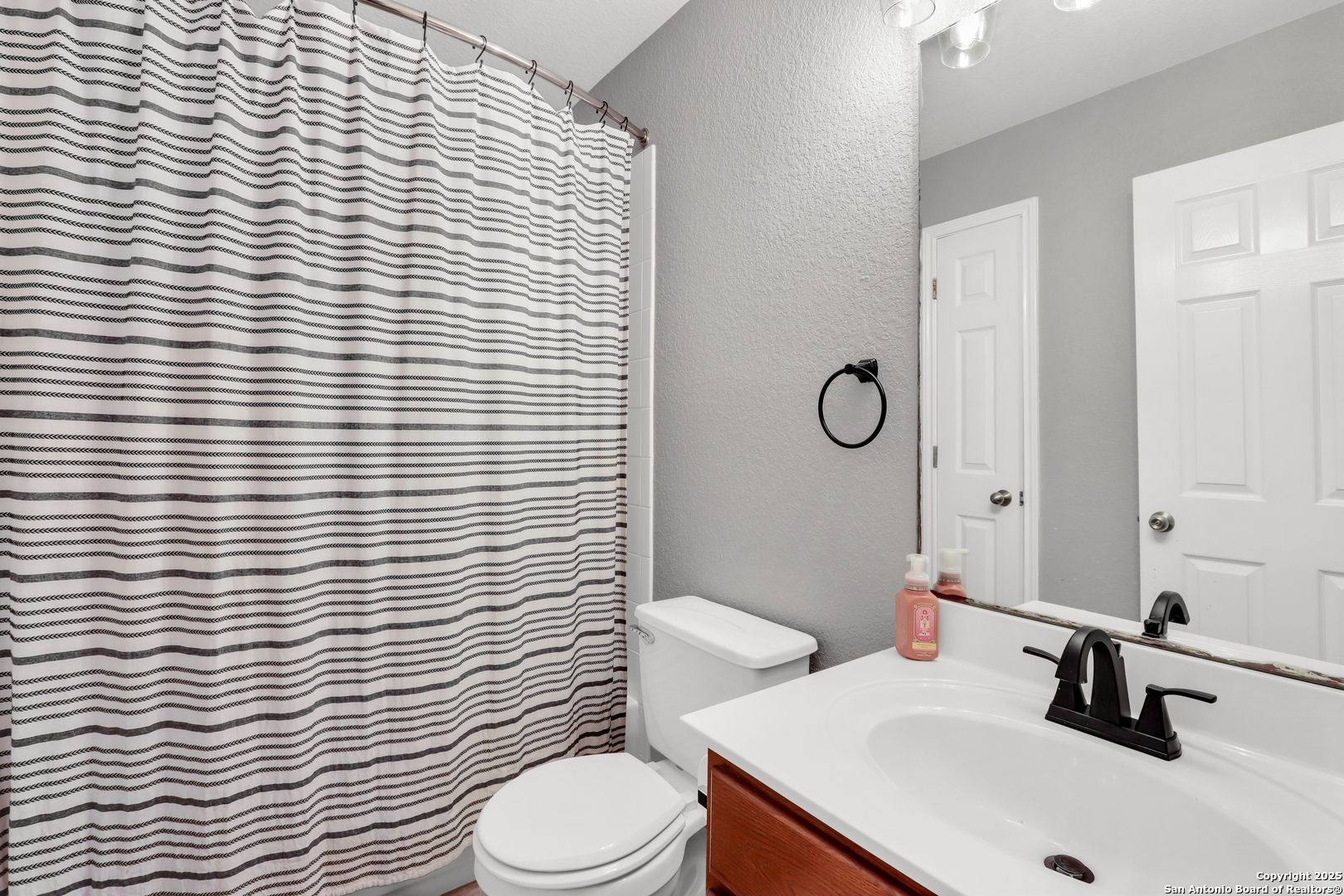 531 Erica Converse, TX 78109 - Photo 10 of 30 a bathroom with a sink a toilet and mirror