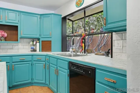 a kitchen with a sink cabinets and a large window
