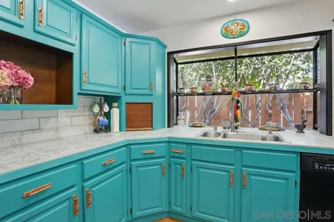 a kitchen with cabinets and window
