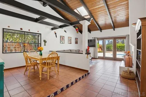 a dining room with furniture a rug and a large window