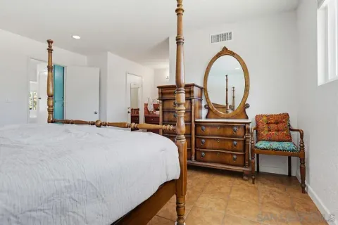 a bed room with a bed and a television