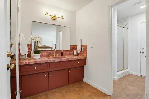 a spacious bathroom with a double vanity sink and a mirror
