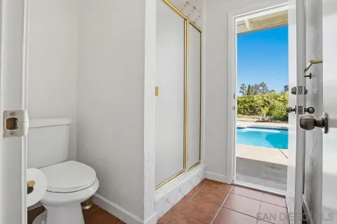 a bathroom with a toilet and a shower