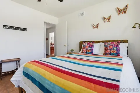 a bedroom with a bed and a couch